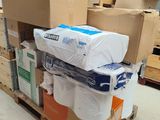 many rolls of toilet paper on a pallet in a warehouse