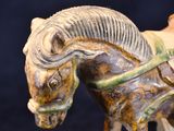 a statue of a horse with a saddle on it ' s back