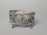 a silver bowl with a design on it sitting on a table
