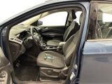 the interior of a car with the door open and the driver ' s seat down