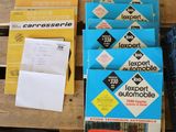 a lot of books on a pallet next to a red truck