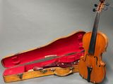 an old violin in a case on a gray background