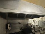 a kitchen with a stove, oven, and sink in it