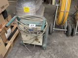 a stack of boxes and a cart in a warehouse