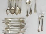 a lot of silver spoons and forks on the table