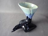 a black and white vase with a blue design on it