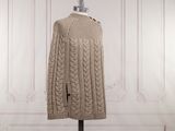 a close up of a sweater on a mannequin stand in a room