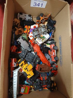 a cardboard box filled with assorted toy vehicles
