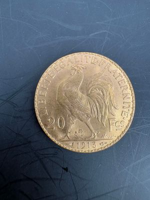 a close up of a gold coin on a blue surface