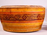 a yellow and red bowl sitting on a white surface