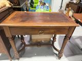 a small table with a drawer on top of it