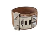 leather cuff bracelet with rivets and rivets on a white background