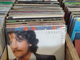 a lot of vinyl records in a box on the table