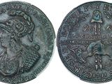 a close up of a coin with a woman on it