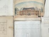 many drawings of a building on a table