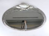 a person taking a picture of a mirror with a camera