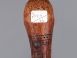a close up of a wooden walking stick with a tag on it