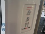 a white refrigerator with a sticker on the side of it
