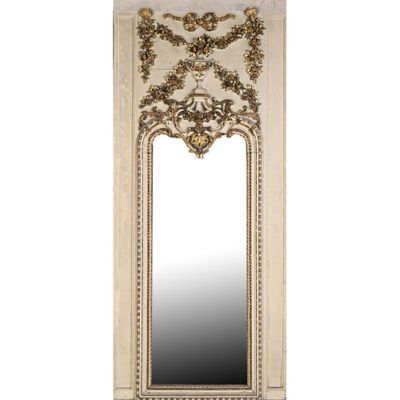 a white mirror with a gold frame and ornate design