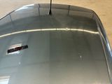 a sticker on the hood of a silver car