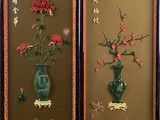 two framed pictures of flowers in a vase on the wall