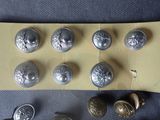 a lot of buttons that are sitting on a piece of paper