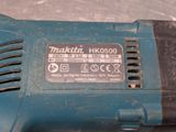 a close up of a blue electric tool on a table