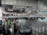 many glasses and bottles on the counter in the bar