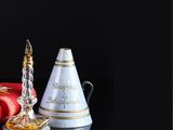 bottles of perfume and a candle on a table with a black background