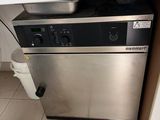a silver dishwasher sitting on top of a kitchen counter