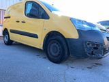 yellow van parked in a parking lot with other cars in the background