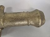 a metal pipe that is on a white surface