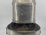 a silver pot sitting on top of a metal pan