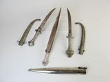 four different types of knives and a knife holder on a white surface