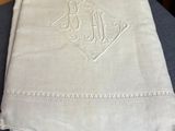 a white cloth with a monogram on it sitting on a table