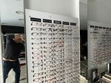 a man standing in front of a display of glasses