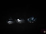 three blue topazte faceted stones on a black background