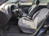 the interior of a car with a grey seat cover and a black steering wheel