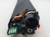a small piece of black plastic that has been removed from the printer