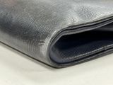 grey fabric with a zipper on top of it on a white surface