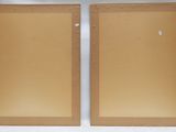 pair of wooden picture frames with holes in them on a white background