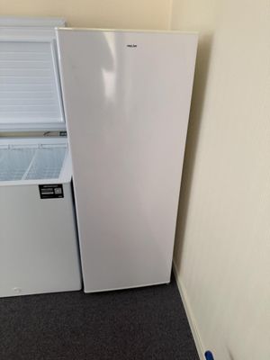 a refrigerator and freezer in the corner of a room