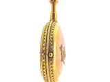 a gold locke with a picture on it hanging from a chain