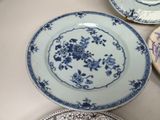several blue and white plates are sitting on a table