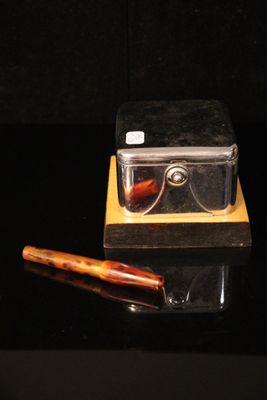 a pair of glasses and a pen sitting on a table