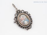 a close up of a necklace with a picture of a woman on it