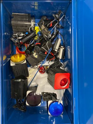 a blue box filled with assorted electronics and other items