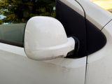 a close up of a side view mirror on a white car