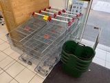 many shopping carts lined up in a row in a store