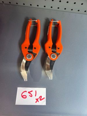 two pairs of orange pliers on display in a store